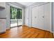 Hallway with wood floors, a sliding glass door to the backyard deck, and a double door closet at 1131 Hershey Dr, Marietta, GA 30062