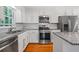 Bright kitchen features stainless steel appliances, granite countertops and white subway tile backsplash at 1131 Hershey Dr, Marietta, GA 30062