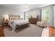 Spacious main bedroom with hardwood floors, ceiling fan, and large windows at 1131 Hershey Dr, Marietta, GA 30062