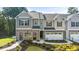 Charming townhome with a brick and siding facade, featuring a one-car garage and well-maintained landscaping at 1317 Aura Ln, Lawrenceville, GA 30045