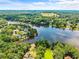 Breathtaking aerial view featuring lakefront estates surrounded by lush greenery, showcasing serene waterfront properties at 55 Moray Pl, Covington, GA 30014