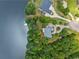Stunning aerial view of lakefront homes surrounded by lush greenery and mature trees, offering serene waterfront living at 55 Moray Pl, Covington, GA 30014