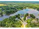 Expansive aerial view of luxury homes nestled by a tranquil lake, surrounded by dense trees and picturesque landscapes at 55 Moray Pl, Covington, GA 30014