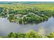Aerial view of homes on a tranquil lake surrounded by lush green forests at 55 Moray Pl, Covington, GA 30014