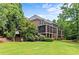 Back of house features a screened in patio, brick stairs and large yard perfect for outdoor enjoyment at 55 Moray Pl, Covington, GA 30014