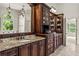 Bathroom featuring custom cabinets, dual sinks, granite counters and designer lighting at 55 Moray Pl, Covington, GA 30014