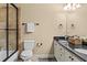 Well-lit bathroom featuring a double vanity with dark countertops and a glass-enclosed shower with beige tile at 55 Moray Pl, Covington, GA 30014