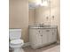 Clean bathroom featuring granite counters, white cabinets, and a neutral color palette at 55 Moray Pl, Covington, GA 30014