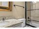 Bathroom featuring granite counters, a bathtub with tiled walls and glass, and dark hardware at 55 Moray Pl, Covington, GA 30014