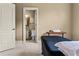 Bedroom featuring hardwood floors, a doorway to an ensuite bathroom, and a massage table at 55 Moray Pl, Covington, GA 30014