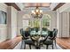 Bright dining room with a glass table set, chairs, and large windows offering a scenic view at 55 Moray Pl, Covington, GA 30014