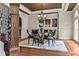 Elegant dining room features a round glass table, six chairs, hardwood floors, and sophisticated decor at 55 Moray Pl, Covington, GA 30014
