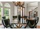 Dining room with glass table, ornate chairs, and views to the foyer and entry at 55 Moray Pl, Covington, GA 30014
