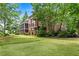 Beautiful backyard with a lush green lawn and mature trees surrounding the property at 55 Moray Pl, Covington, GA 30014