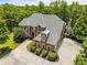 Elegant brick home on a vast lot with a lake view, showcasing meticulous landscaping and architectural detail at 55 Moray Pl, Covington, GA 30014