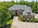 Stately brick home featuring manicured landscaping and mature trees providing shade and privacy at 55 Moray Pl, Covington, GA 30014