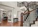 Stately foyer highlighting an elegant staircase with wrought iron details and refined interior finishes at 55 Moray Pl, Covington, GA 30014