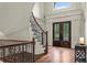 Entry foyer with staircase and iron railing, and front door with decorative glass at 55 Moray Pl, Covington, GA 30014
