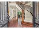 Grand foyer boasting a curved staircase with iron railings and hardwood floors, showcasing an open layout at 55 Moray Pl, Covington, GA 30014