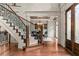 Grand foyer with a curved staircase, hardwood flooring, and an open view into the adjacent dining room at 55 Moray Pl, Covington, GA 30014