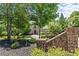 Charming brick residence with a circular driveway, lush greenery, and elegant curb appeal at 55 Moray Pl, Covington, GA 30014