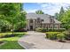 Stately brick home with lush landscaping, arched windows, and a circular driveway for grand curb appeal at 55 Moray Pl, Covington, GA 30014