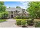 Brick front exterior with beautiful landscaping, an arched entry, and a spacious circular driveway at 55 Moray Pl, Covington, GA 30014