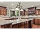 Gourmet kitchen featuring stone countertops, stainless steel appliances, and rich wood cabinetry at 55 Moray Pl, Covington, GA 30014