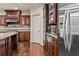 Gourmet kitchen featuring stainless steel appliances and rich wood cabinetry at 55 Moray Pl, Covington, GA 30014