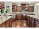 Gourmet kitchen featuring granite counters, stainless steel appliances, and custom wood cabinets at 55 Moray Pl, Covington, GA 30014