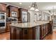 Spacious kitchen with stainless steel appliances and large kitchen island with stone countertops at 55 Moray Pl, Covington, GA 30014