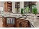 Gourmet kitchen featuring stone countertops, stainless steel appliances, and a bay window overlooking the backyard at 55 Moray Pl, Covington, GA 30014