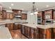 Spacious kitchen featuring granite countertops, custom wood cabinets, and stainless steel appliances at 55 Moray Pl, Covington, GA 30014