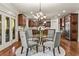 Eat-in kitchen features a glass dining table, chandelier lighting, and wood cabinets at 55 Moray Pl, Covington, GA 30014