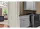 Well-appointed laundry room featuring sleek cabinetry and modern washer and dryer at 55 Moray Pl, Covington, GA 30014