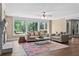 Bright living room with large windows, fireplace, and hardwood floors at 55 Moray Pl, Covington, GA 30014