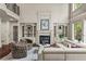 Living room featuring fireplace, built-in shelves, hardwood floors, and large windows for natural light at 55 Moray Pl, Covington, GA 30014