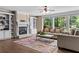 Cozy living room featuring a fireplace with built-ins and large windows for natural light at 55 Moray Pl, Covington, GA 30014