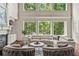 Bright living room features large windows, hardwood floors, and comfortable seating area at 55 Moray Pl, Covington, GA 30014