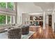 Open living area with large windows, hardwood floors, and a kitchen view at 55 Moray Pl, Covington, GA 30014