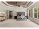 Luxurious main bedroom featuring a decorative ceiling, large windows, and elegant furnishings at 55 Moray Pl, Covington, GA 30014