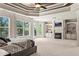 Spacious main bedroom with tray ceiling, fireplace, built-ins and a view of surrounding trees at 55 Moray Pl, Covington, GA 30014