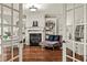 Serene office space featuring a fireplace, built-in bookshelves, and French doors for an inviting atmosphere at 55 Moray Pl, Covington, GA 30014