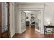 Bright office with French doors, a cozy fireplace, built-in bookshelves, and elegant hardwood floors at 55 Moray Pl, Covington, GA 30014