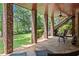 Covered stone patio with comfortable seating and views of the backyard at 55 Moray Pl, Covington, GA 30014