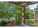 Relaxing patio with a brick pillar overlooking a lush green landscape and lake at 55 Moray Pl, Covington, GA 30014