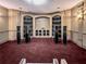 Elegant theater room with built-in shelving and surround sound speakers for an immersive viewing experience at 55 Moray Pl, Covington, GA 30014