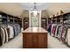 Spacious walk-in closet featuring custom shelving, a central island, and ample storage space at 55 Moray Pl, Covington, GA 30014