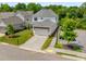 Aerial view of a two-story home with a two-car garage and well-manicured yard at 6320 Halcyon Garden Dr, Alpharetta, GA 30005