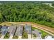 Aerial view of neighborhood and home with wooded backdrop at 6320 Halcyon Garden Dr, Alpharetta, GA 30005